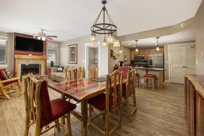 a dining room and living room with a table and chairs at Value Unit 4440 - Two Bedroom - Fraser Crossing Founders Pointe condo in Winter Park