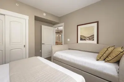 a bedroom with two beds and a couch at Value Unit 4440 - Two Bedroom - Fraser Crossing Founders Pointe condo in Winter Park