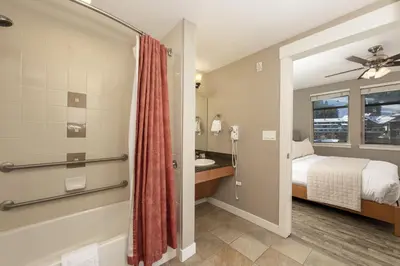 a bedroom with a bed and a bathroom with a shower at Value Unit 4440 - Two Bedroom - Fraser Crossing Founders Pointe condo in Winter Park