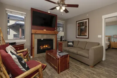 a living room with a couch and a fireplace at Value Unit 4440 - Two Bedroom - Fraser Crossing Founders Pointe condo in Winter Park