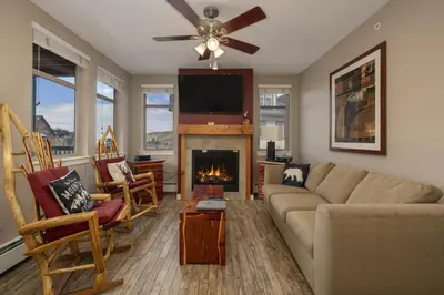 a living room with a couch and a fireplace at Value Unit 4440 - Two Bedroom - Fraser Crossing Founders Pointe condo in Winter Park
