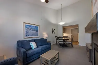 a living room with a blue couch and a table at Winter Park FF Premium-Rated 3619 in Winter Park