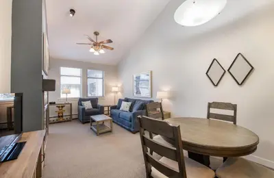 a living room with a table and a couch at Winter Park FF Premium-Rated 3619 in Winter Park