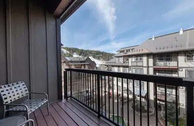 a balcony with a chair and a view of a building at Winter Park FF Premium-Rated 3619 in Winter Park