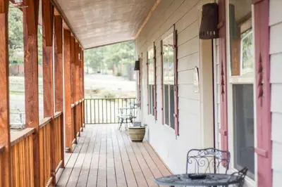 a porch with a table and benches on a house at Old Man Mountain, Spacious lodge with loft Great for families, Dogs allowed in Estes Park