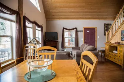 a living room with a table and a couch at Old Man Mountain, Spacious lodge with loft Great for families, Dogs allowed in Estes Park