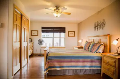a bedroom with a bed and a ceiling fan at Old Man Mountain, Spacious lodge with loft Great for families, Dogs allowed in Estes Park