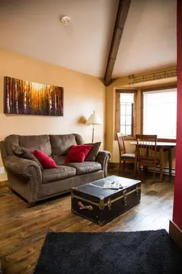a living room with a couch and a table at Sundance Suite, 1 Bedroom with fireplace Dogs OK in Estes Park