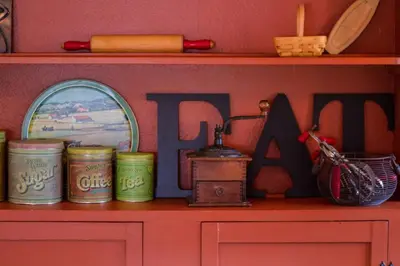 a shelf with jars and a mirror on top of it at Prospect Cabin, Cozy 1-bedroom cabin with kitchen Dogs OK in Estes Park