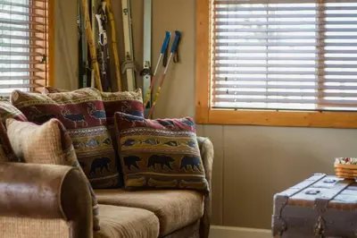 a living room with a couch and a window at Prospect Cabin, Cozy 1-bedroom cabin with kitchen Dogs OK in Estes Park