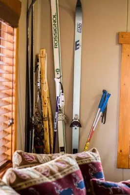 a bunch of skis and poles are hanging on a wall at Prospect Cabin, Cozy 1-bedroom cabin with kitchen Dogs OK in Estes Park