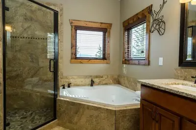 a bathroom with a tub and a glass shower at Spacious 2nd story loft with awesome views in Estes Park