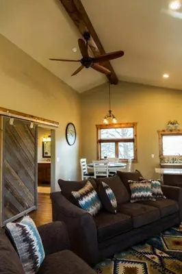 a living room with a couch and a ceiling fan at Spacious 2nd story loft with awesome views in Estes Park