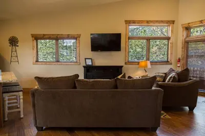 a living room with a couch and a tv at Spacious 2nd story loft with awesome views in Estes Park