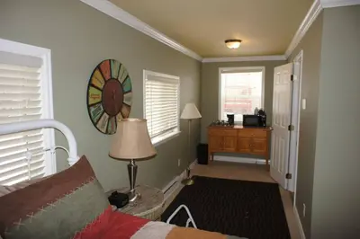 a room with a bed and a table with a lamp at Mt Olympus Cabin, Cozy 1 bedroom cabin Great for couples in Estes Park
