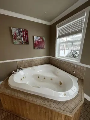 a large bath tub in a bathroom with a window at Mt Olympus Cabin, Cozy 1 bedroom cabin Great for couples in Estes Park