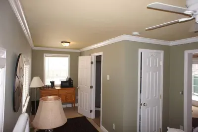 a room with a bedroom with a ceiling fan and a desk at Mt Olympus Cabin, Cozy 1 bedroom cabin Great for couples in Estes Park