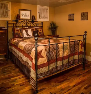 a bedroom with a large bed with a wooden floor at Mummy Mtn Suite 1 Bedroom suite with fireplace and jacuzzi tub in Estes Park