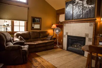 a living room with a couch and a fireplace at Mummy Mtn Suite 1 Bedroom suite with fireplace and jacuzzi tub in Estes Park