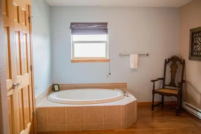 a large bath tub in a bathroom with a window at Twin Owls Lodge, Great for families Master bedroom, Loft, full kitchen, Dogs OK in Estes Park