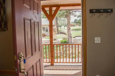 an open door to a porch with a view at Twin Owls Lodge, Great for families Master bedroom, Loft, full kitchen, Dogs OK in Estes Park