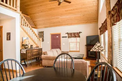 a living room with a table and a couch at Twin Owls Lodge, Great for families Master bedroom, Loft, full kitchen, Dogs OK in Estes Park