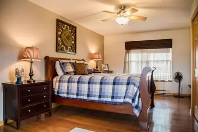 a bedroom with a bed and a ceiling fan at Twin Owls Lodge, Great for families Master bedroom, Loft, full kitchen, Dogs OK in Estes Park