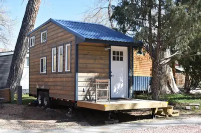 a tiny house sitting on the back of a truck at WeeCasa Tiny Home Resort in Lyons