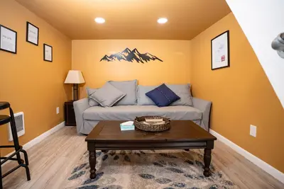 a living room with a couch and a table at WeeCasa Tiny Home Resort in Lyons