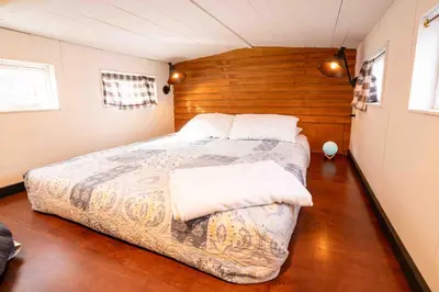 a bedroom with a large bed in a room at WeeCasa Tiny Home Resort in Lyons