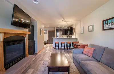 a living room with a couch and a fireplace at Zephyr Mountain Lodge Premium-Rated 1102 in Winter Park