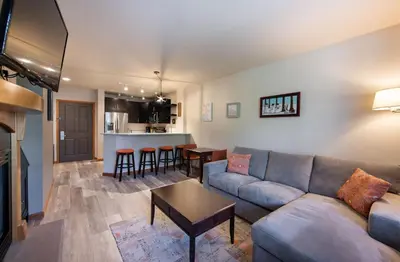 a living room with a couch and a table at Zephyr Mountain Lodge Premium-Rated 1102 in Winter Park