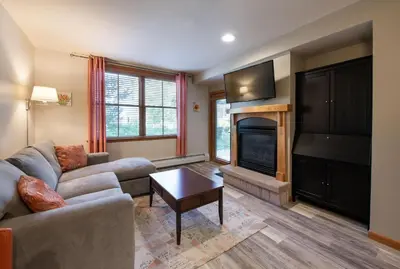 a living room with a couch and a fireplace at Zephyr Mountain Lodge Premium-Rated 1102 in Winter Park