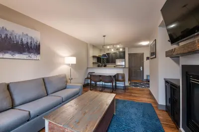 a living room with a couch and a table at Zephyr Mountain Lodge Premium-Rated 1214 in Winter Park