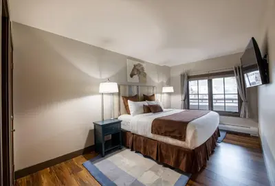 a bedroom with a large bed and a window at Zephyr Mountain Lodge Premium-Rated 1214 in Winter Park