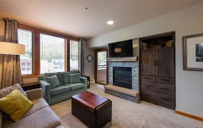 a living room with a couch and a fireplace at Zephyr Mountain Lodge Premium-Rated 2516 in Winter Park