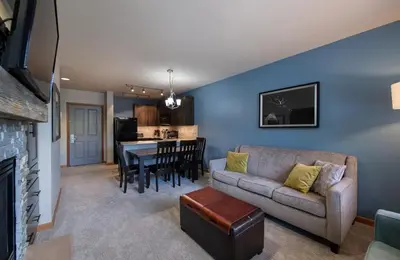 a living room with a couch and a table at Zephyr Mountain Lodge Premium-Rated 2516 in Winter Park
