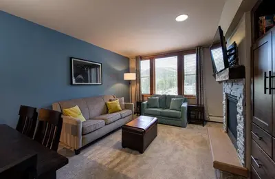 a living room with a couch and a fireplace at Zephyr Mountain Lodge Premium-Rated 2516 in Winter Park