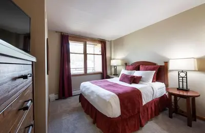 a bedroom with a large bed and a television at Zephyr Mountain Lodge Premium-Rated 2516 in Winter Park