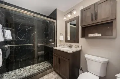 a bathroom with a shower and a toilet and a sink at Zephyr Mountain Lodge Premium-Rated 2516 in Winter Park
