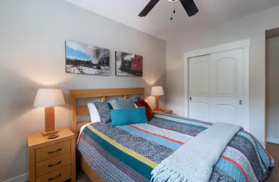 a bedroom with a bed and a dresser and a ceiling fan at Winter Park FF Premium-Rated 4457 in Winter Park