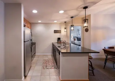 a kitchen with a refrigerator and a counter top at Winter Park FF Premium-Rated 4457 in Winter Park