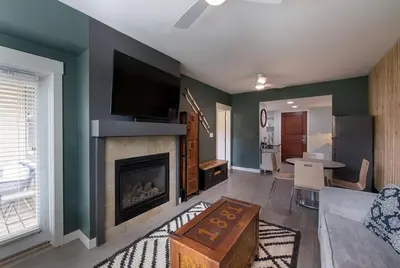 a living room with a fireplace with a flat screen tv at Winter Park FF Premium-Rated 4462 in Winter Park