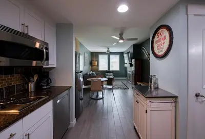 a kitchen with white cabinets and a large clock on the wall at Winter Park FF Premium-Rated 4462 in Winter Park