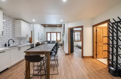 a kitchen with a large wooden table and chairs at Zephyr Mountain Lodge Premium-Rated 2100 in Winter Park