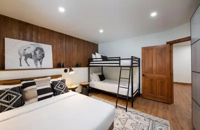 a bedroom with a bed and a bunk bed at Zephyr Mountain Lodge Premium-Rated 2100 in Winter Park