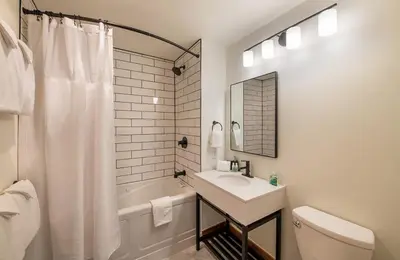a bathroom with a sink and a toilet and a tub at Zephyr Mountain Lodge Premium-Rated 2100 in Winter Park