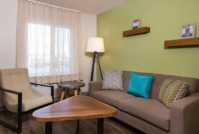 a living room with a couch and a chair at WoodSpring Suites Littleton-South Denver in Littleton