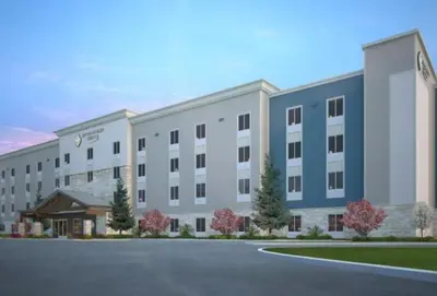 a rendering of a large building with a parking lot at WoodSpring Suites Littleton-South Denver in Littleton