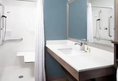 a bathroom with a sink and a shower at WoodSpring Suites Littleton-South Denver in Littleton